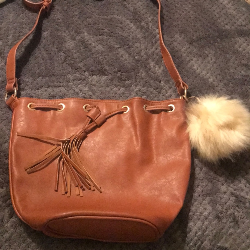 Bucket bag with fringe drawstring.